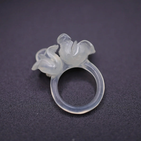 Sublime Ice Magnolia Serpentine Ring featuring crystal-clear serpentine intricately carved into three-dimensional magnolia blossoms, symbolizing purity and natural beauty. The icy, translucent base enhances the floral details, making it a perfect blend of artistry and elegance.