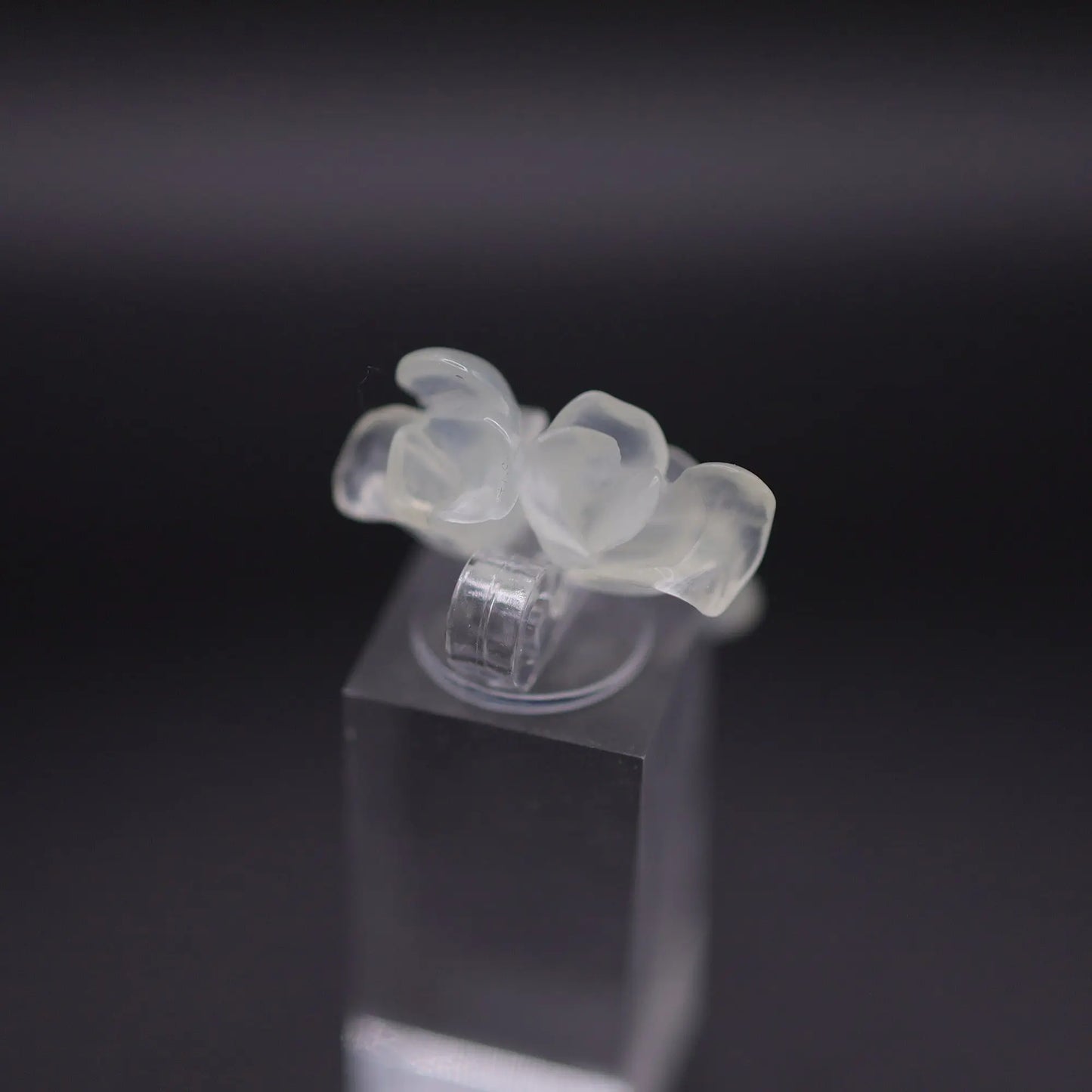 Sublime Ice Magnolia Serpentine Ring featuring crystal-clear serpentine intricately carved into three-dimensional magnolia blossoms, symbolizing purity and natural beauty. The icy, translucent base enhances the floral details, making it a perfect blend of artistry and elegance.