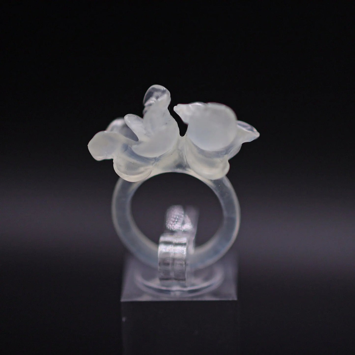 Sublime Ice Magnolia Serpentine Ring featuring crystal-clear serpentine intricately carved into three-dimensional magnolia blossoms, symbolizing purity and natural beauty. The icy, translucent base enhances the floral details, making it a perfect blend of artistry and elegance.