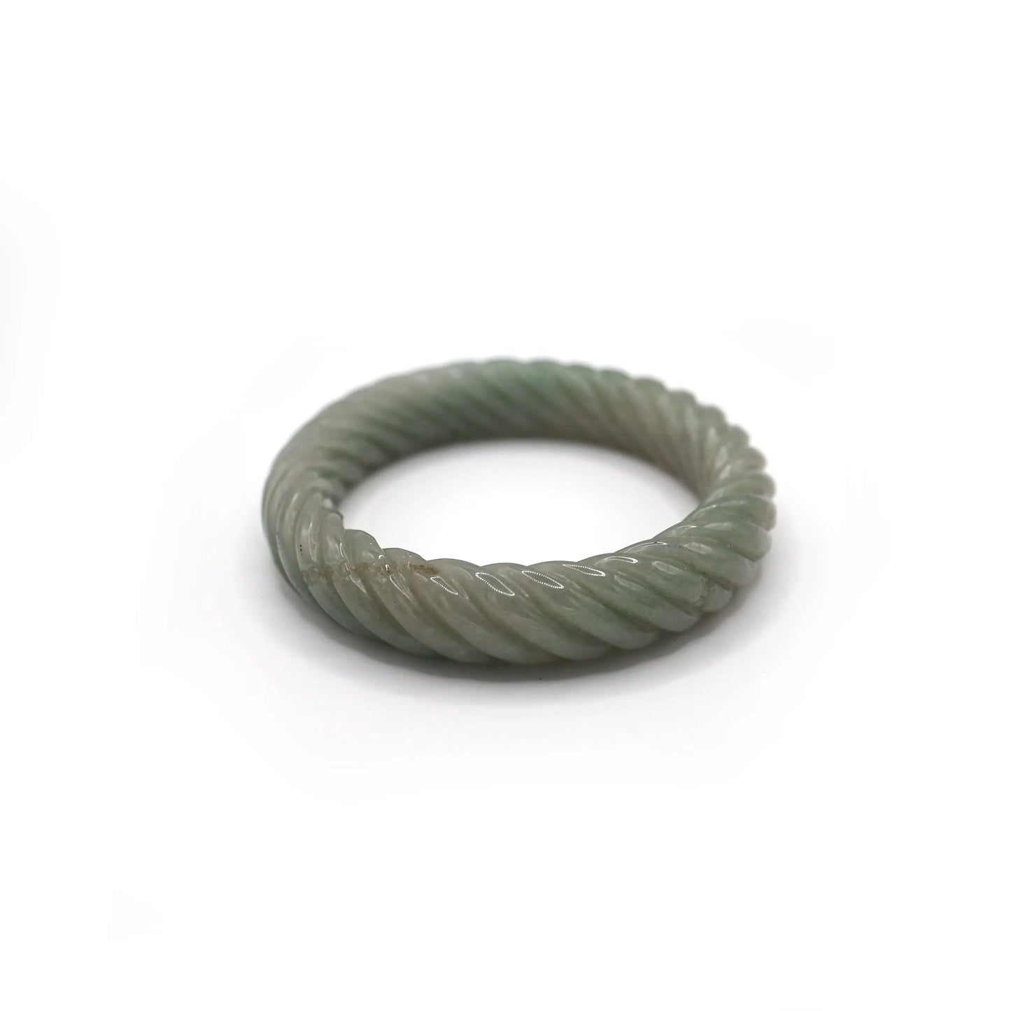 Full-circle Mongolian jade bangle carved in a continuous green twist, accented with two subtle Yuanbao motifs symbolizing prosperity – Miruzi