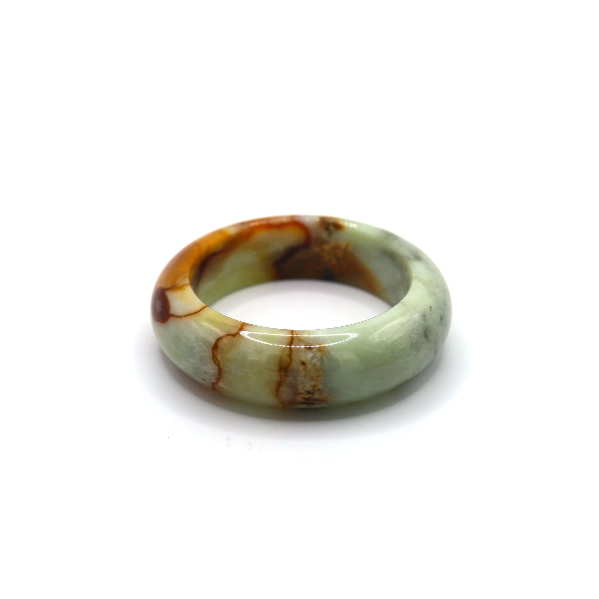 Green jade bangle glowing in daylight, highlighting branching red inclusions Miruzi