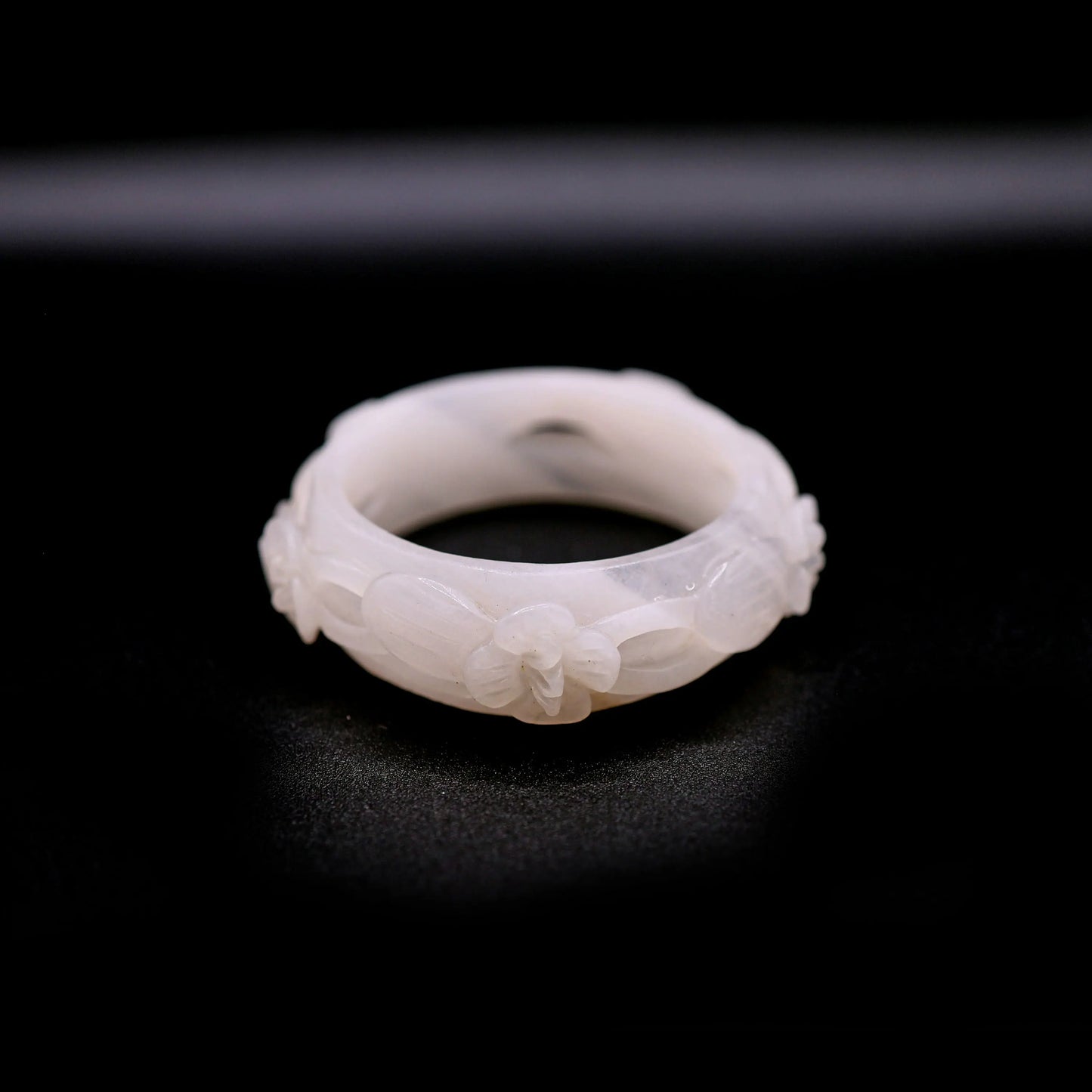 Delicate white jade bangle with five sculpted openwork violets, symbolizing renewal, purity, and blooming feminine energy – Miruzi