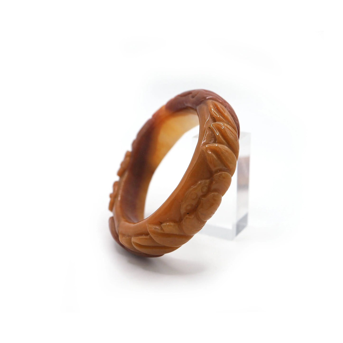 Bold orange jade bracelet with ice-translucent areas and layered floral carvings, blending craftsmanship with natural brilliance – Miruzi