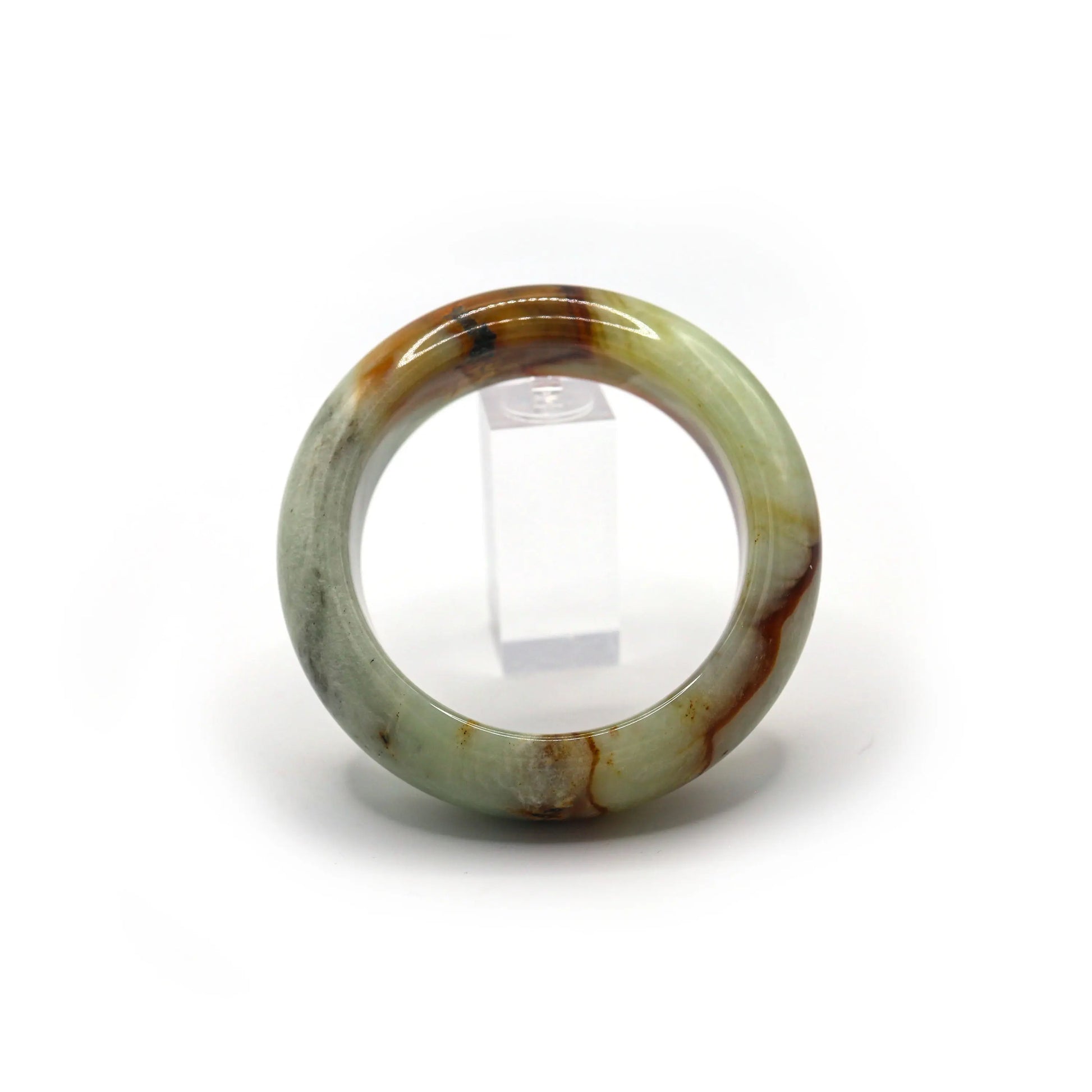 Pale green jade bangle glowing softly under light, red mineral veins clearly visible - Miruzi