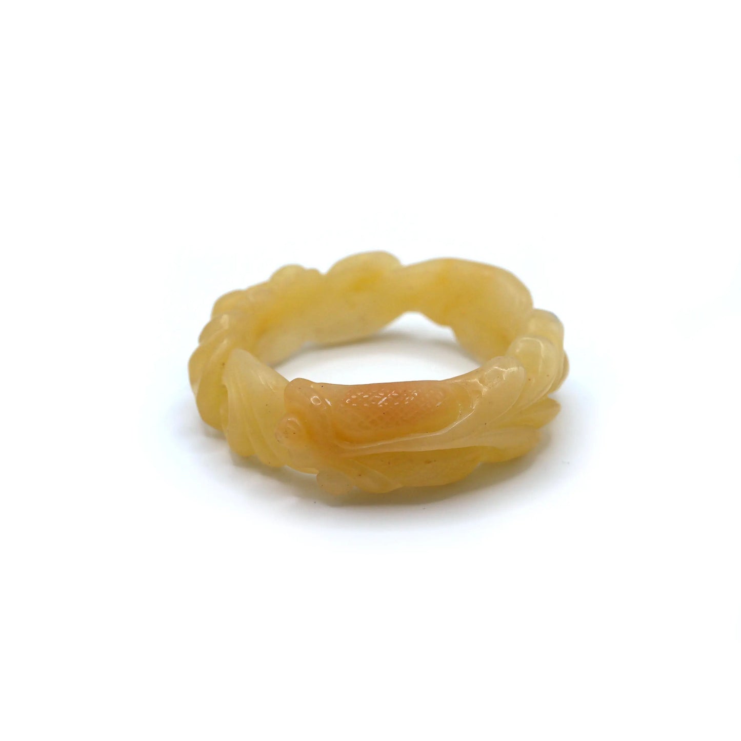 Hand-carved Mongolian yellow jade bracelet featuring a detailed goldfish swimming among lotus flowers, glowing with warm translucence – Miruzi