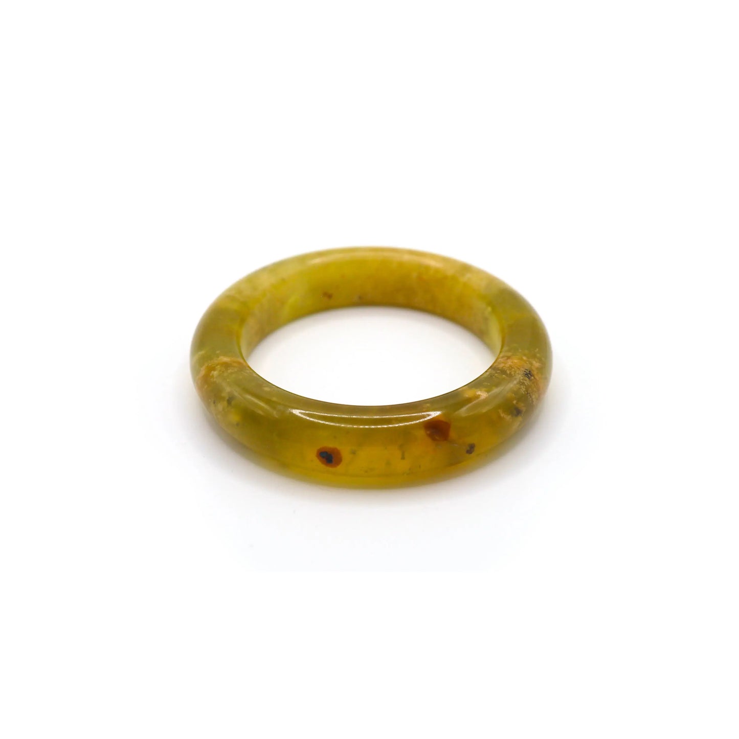 A delicate yellow jade bangle with ice-clear translucence and soft organic veining, styled on natural linen for an elegant presentation. - Miruzi