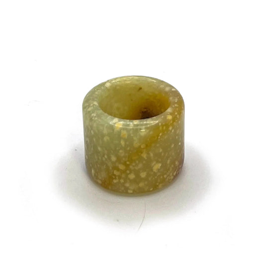 Blizzard Arch lemon yellow thumb ring made from serpentine jade, featuring snowy white patterns and an orange arc—artisan-crafted jade rings for sale.
