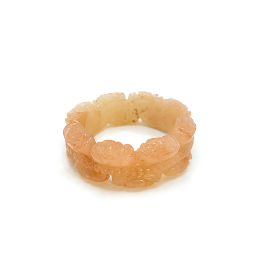 Bangle for small wrist carved from Mongolian jade, featuring double rose bouquet loops with orange-pink translucent finish and star-like natural stone patterns.