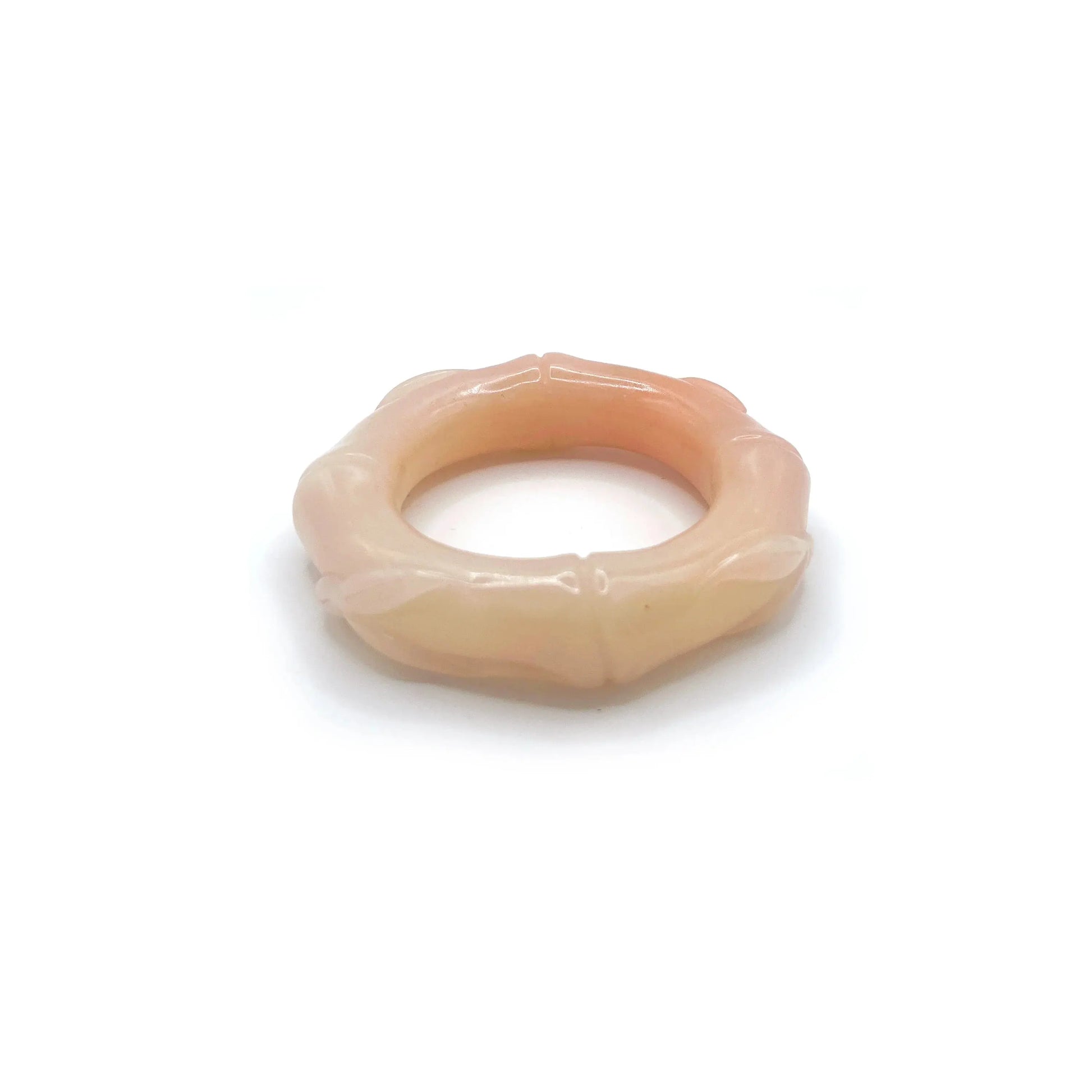 Hand-carved bamboo bangle made from natural Mongolian jade, featuring soft pink, orange, and beige hues with a polished finish and segmented bamboo design.