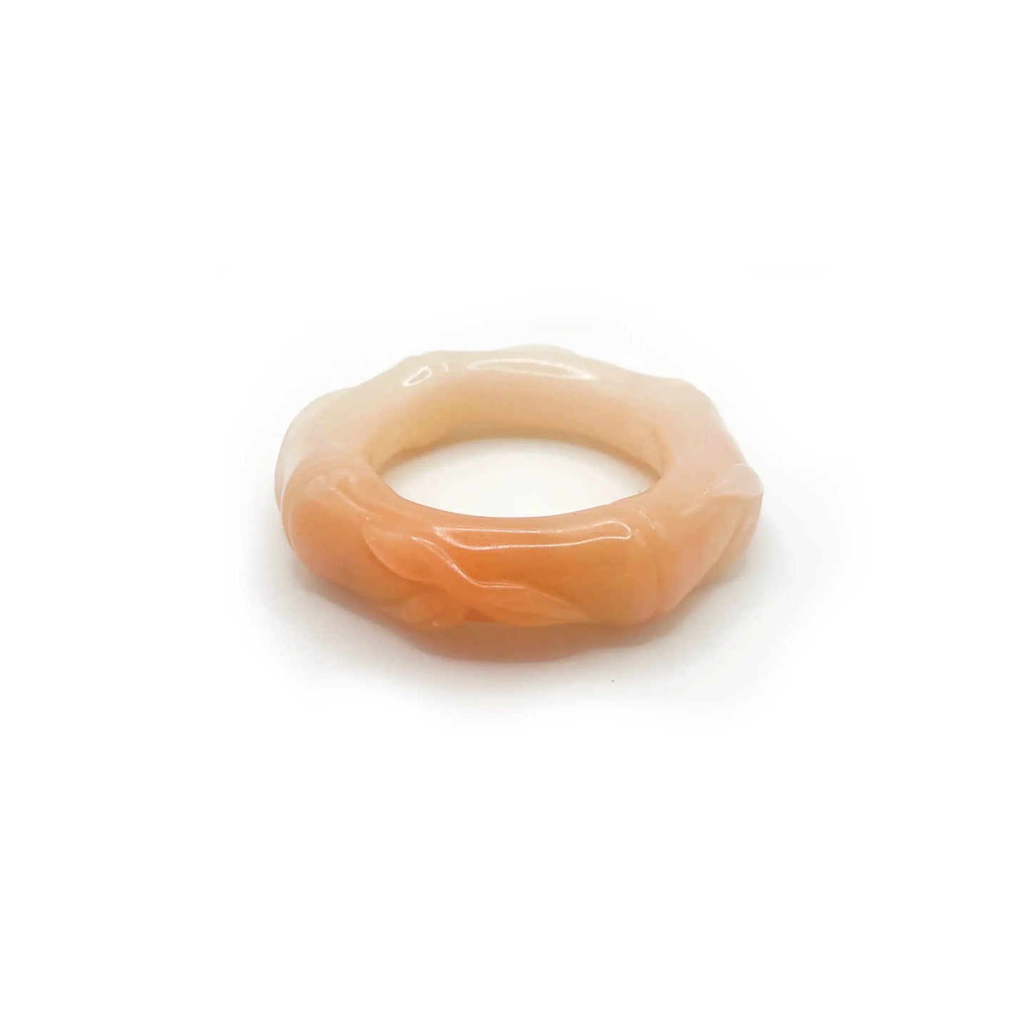 Hand-carved bamboo bangle made from natural Mongolian jade, featuring soft pink, orange, and beige hues with a polished finish and segmented bamboo design.
