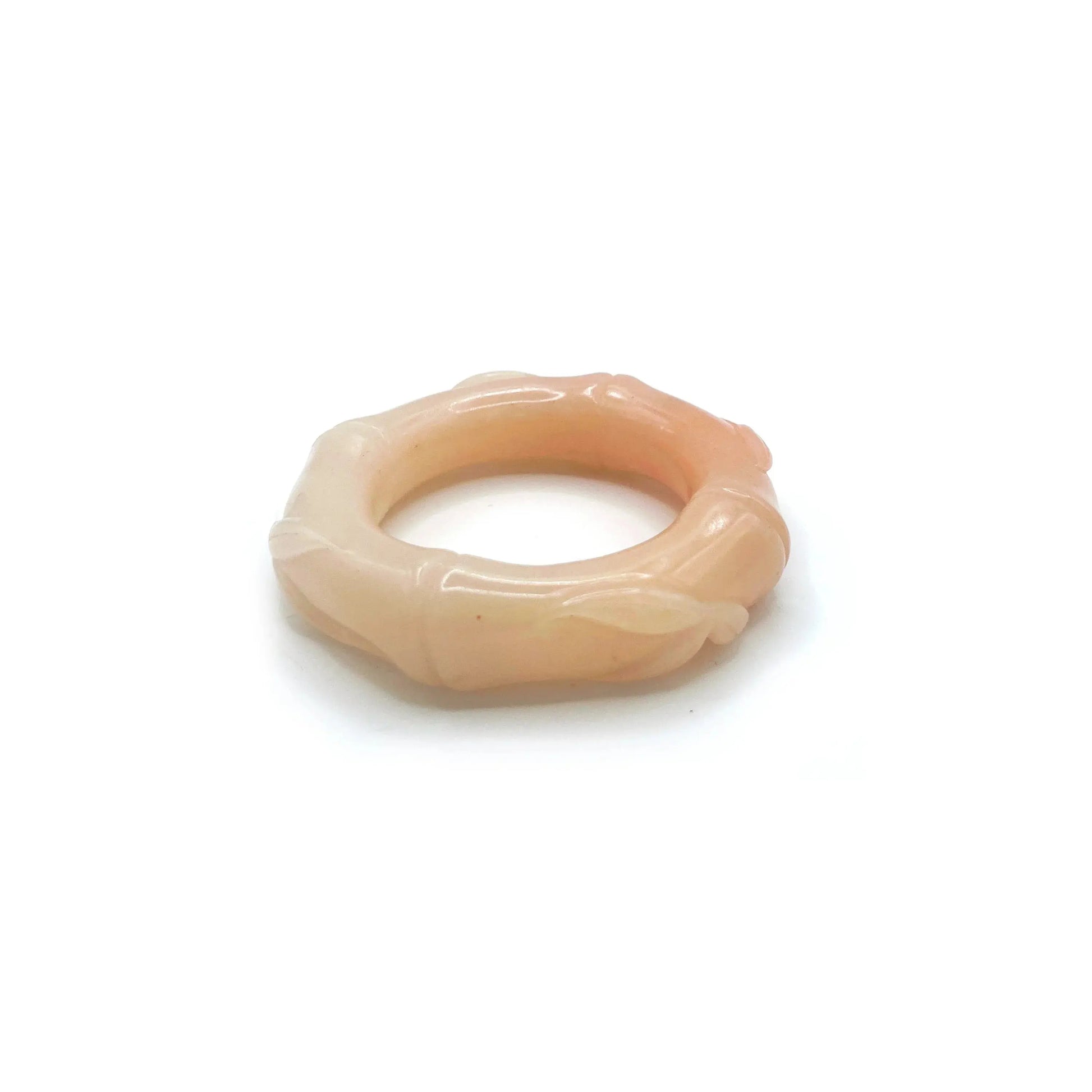 Hand-carved bamboo bangle made from natural Mongolian jade, featuring soft pink, orange, and beige hues with a polished finish and segmented bamboo design.