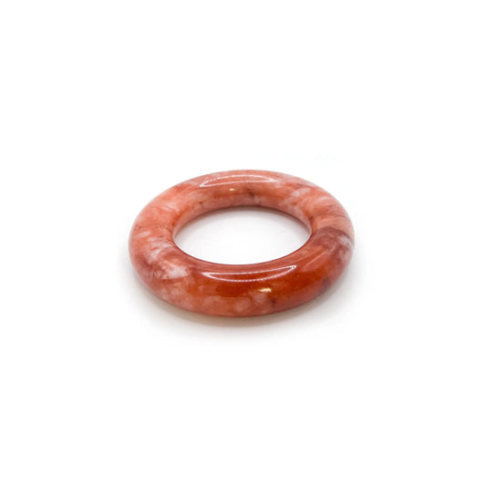 Donut bangle carved from Mongolian jade quartzite in swirling red, pink, and white hues, featuring a smooth round shape and romantic, artistic finish. - Miruzi