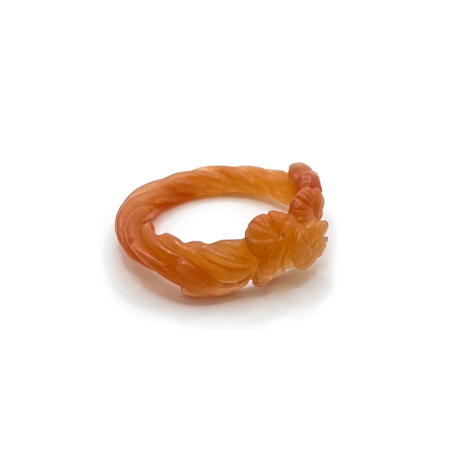 Carved bangle made from translucent Mongolian jade quartzite in orange-yellow tones, featuring delicately etched floral motifs and a glowing, sunset-inspired finish. - Miruzi