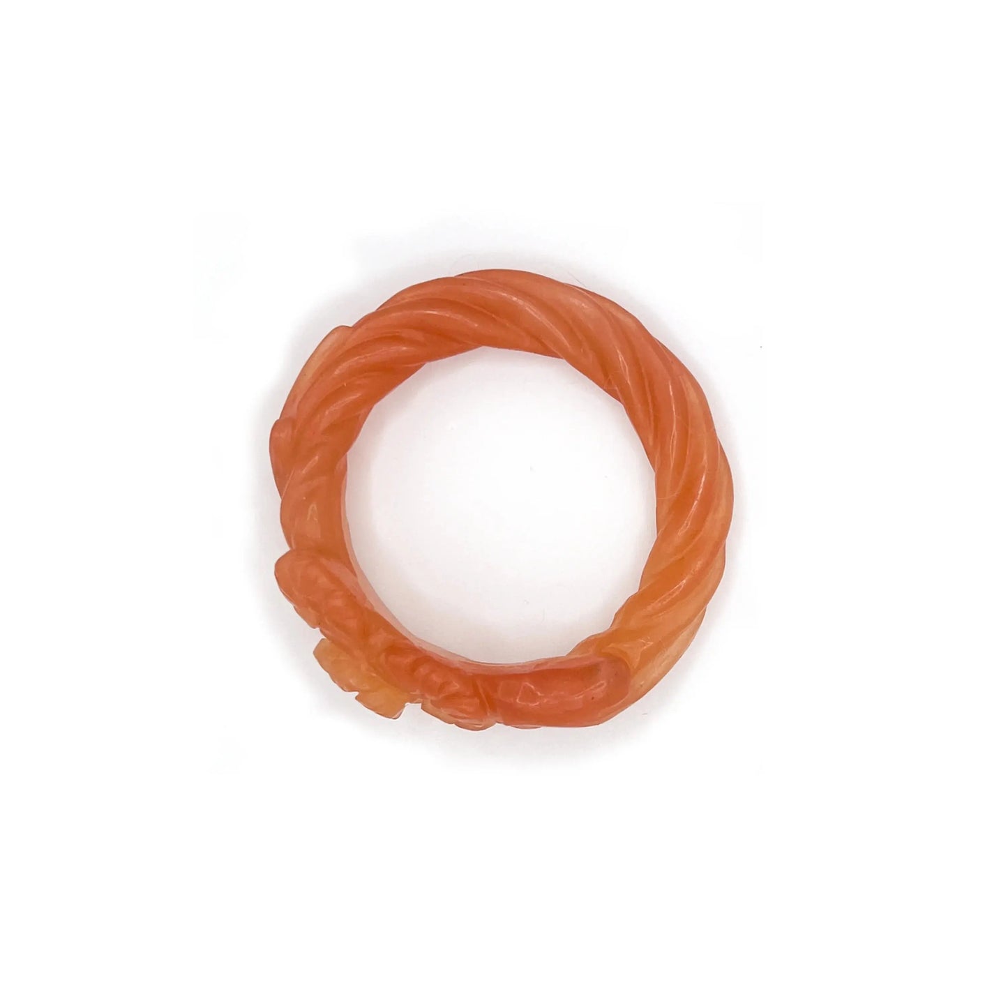 Carved bangle made from translucent Mongolian jade quartzite in orange-yellow tones, featuring delicately etched floral motifs and a glowing, sunset-inspired finish. - Miruzi