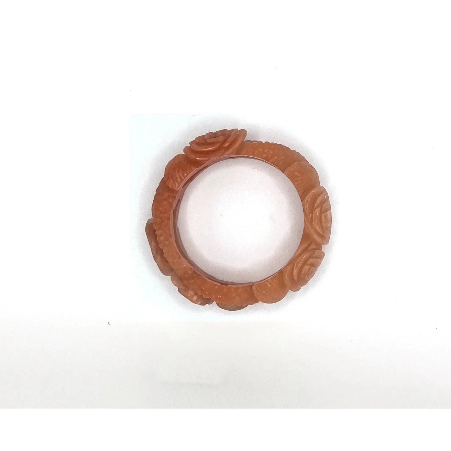 Carved bangle bracelet made from Mongolian jade quartzite, featuring hand-carved roses along a hollowed vine design in soft pink and orange tones.- Miruzi
