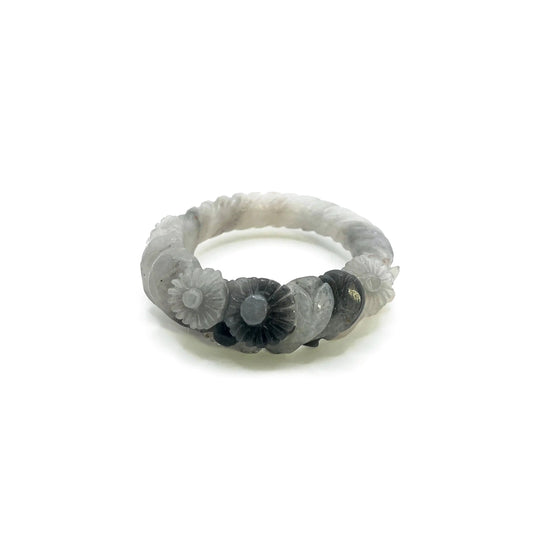 Daisy bangle made from Mongolian jade quartzite, featuring hand-carved white floral motifs that glow like blossoms under moonlight. - Miruzi