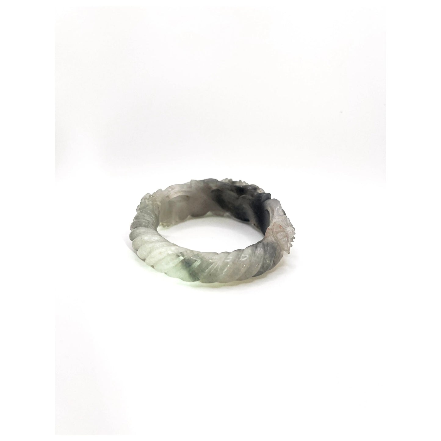 Daisy bangle made from Mongolian jade quartzite, featuring hand-carved white floral motifs that glow like blossoms under moonlight. - Miruzi