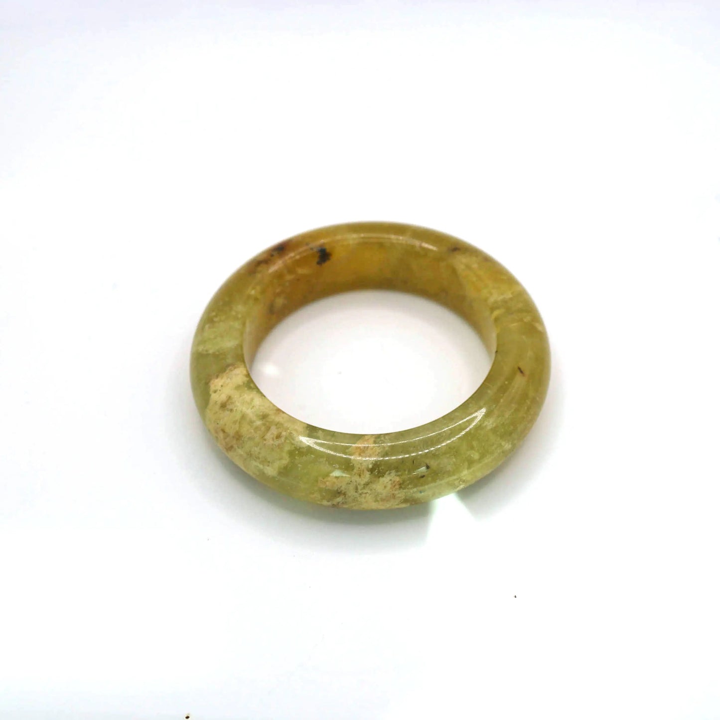 Hand-carved jade bangle featuring ice-like golden hue and softly layered mineral textures