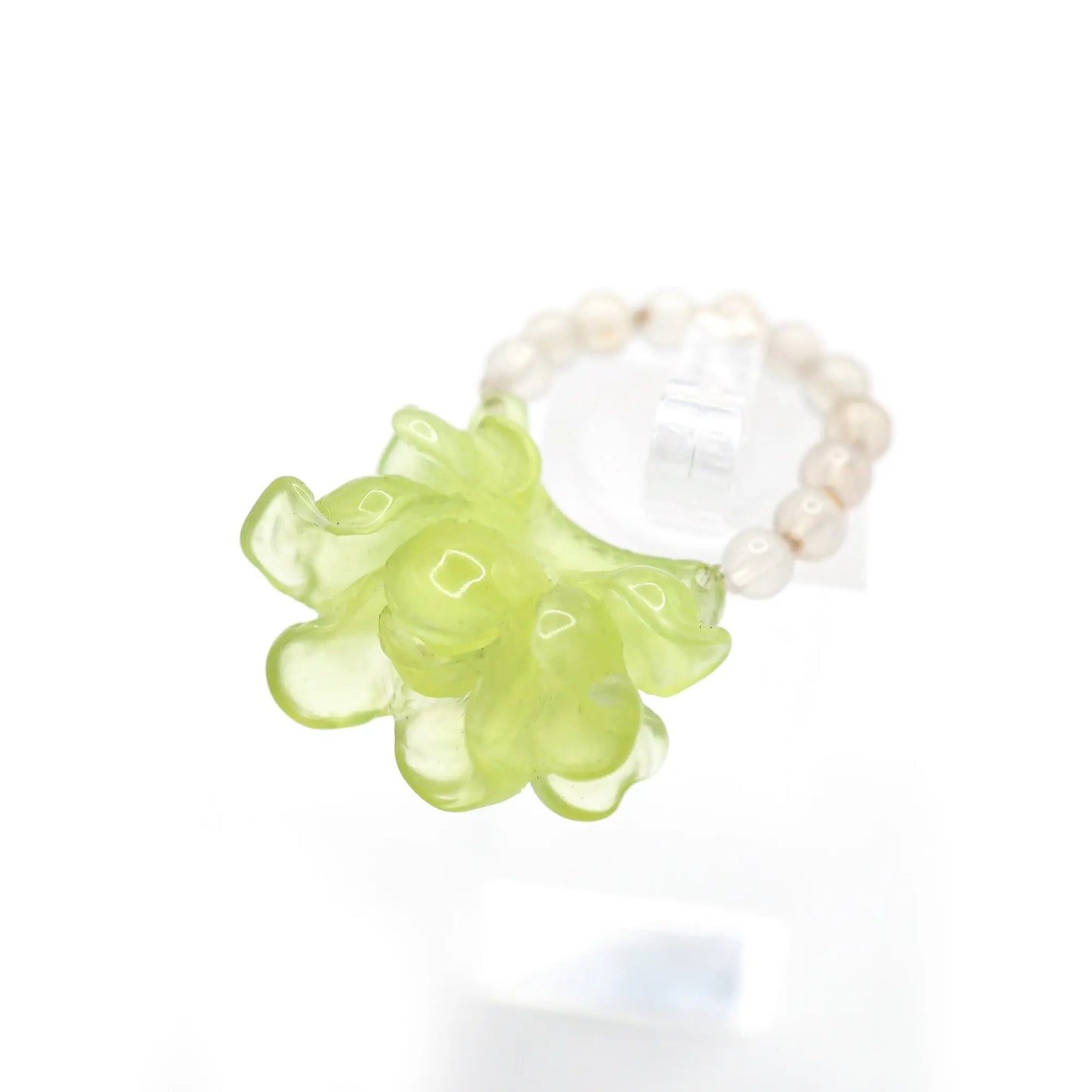 Adjustable lemon yellow ring with carved peony design in translucent serpentine, embodying summer elegance.