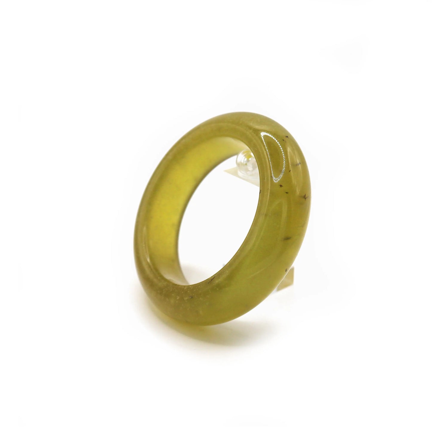 Transparent beer-yellow jade bracelet with visible internal texture and natural bubbles rising beneath the surface. Miruzi