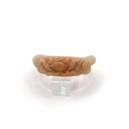 Elegant quartzite jade bracelet combining a smooth twist with intricate floral carving, blending natural flow and refined craftsmanship – Miruzi