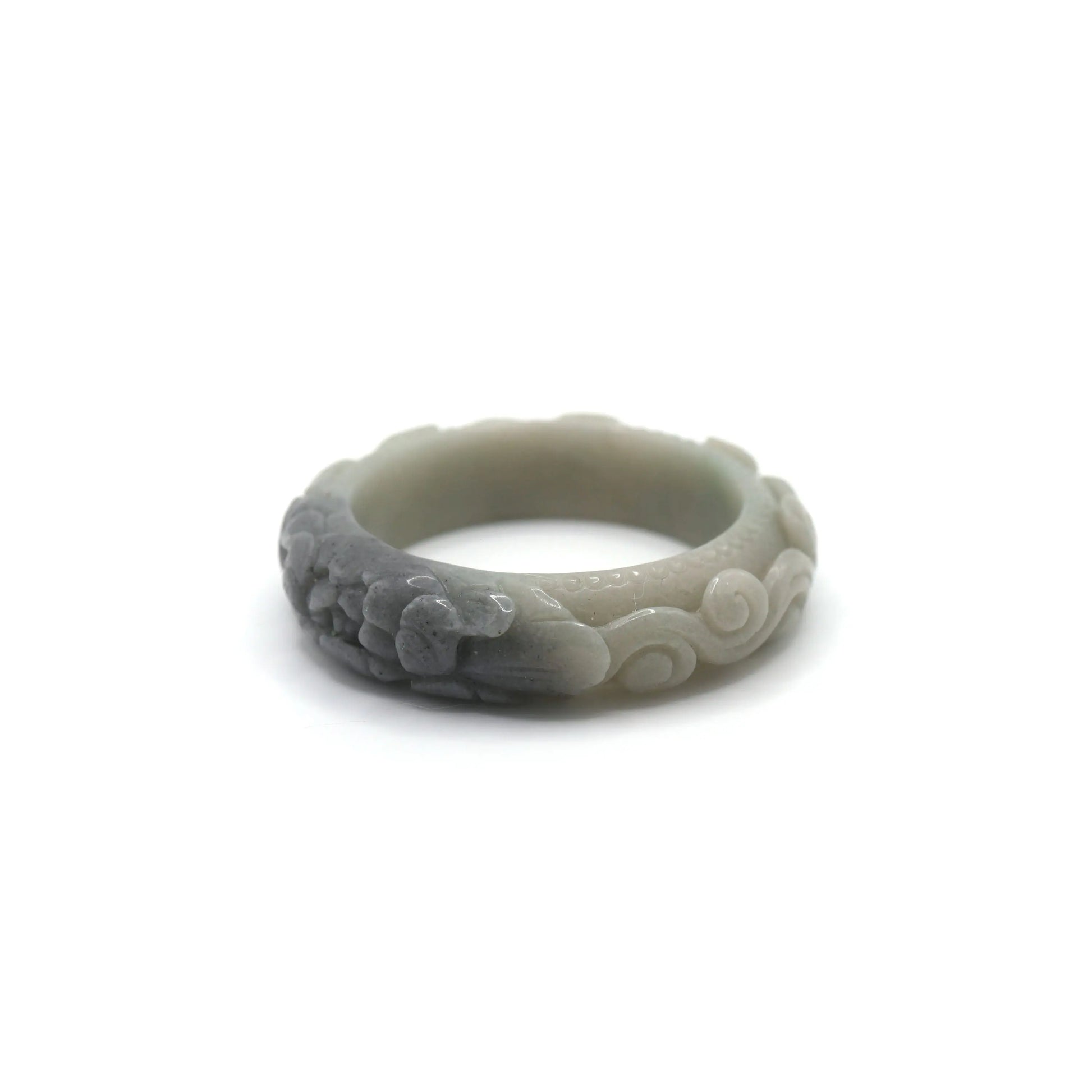 A carved jade bracelet in green quartzite with subtle surface veining, highlighting symbolic relief work of peony and swirling clouds – Miruzi