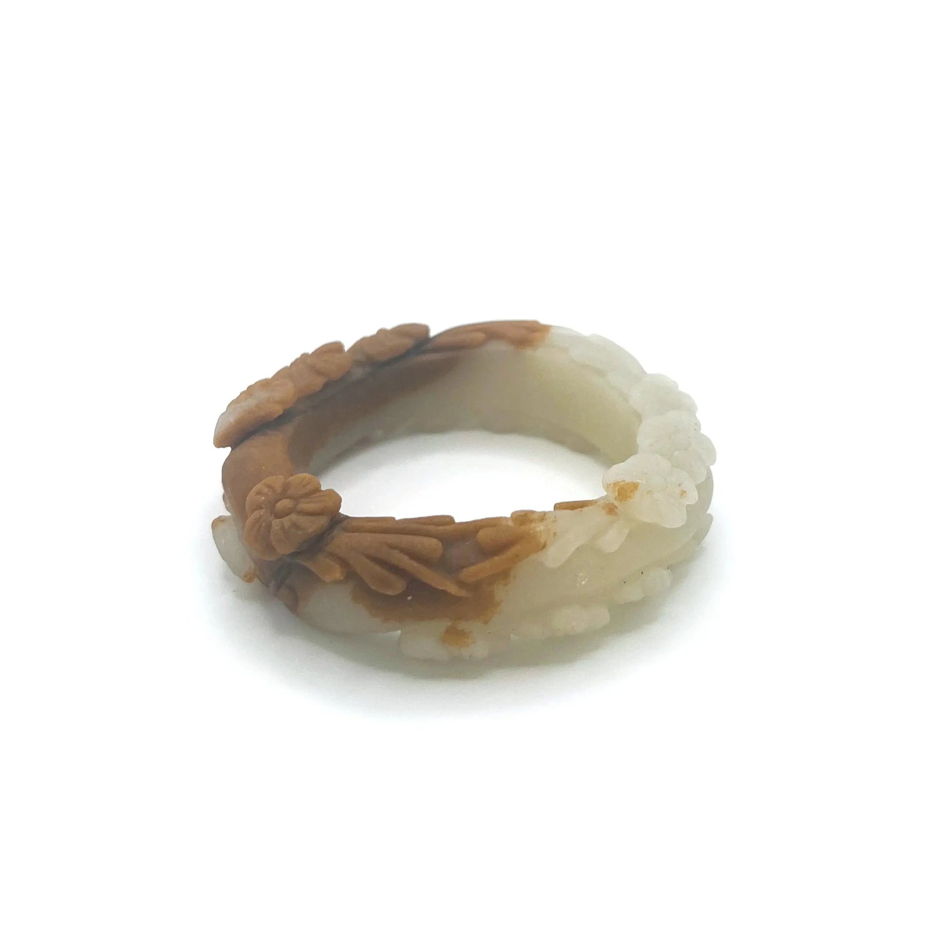 Carved jade bangle featuring three-dimensional floral motifs in warm caramel-colored Mongolian quartzite, hand-carved with an earthy and elegant finish.