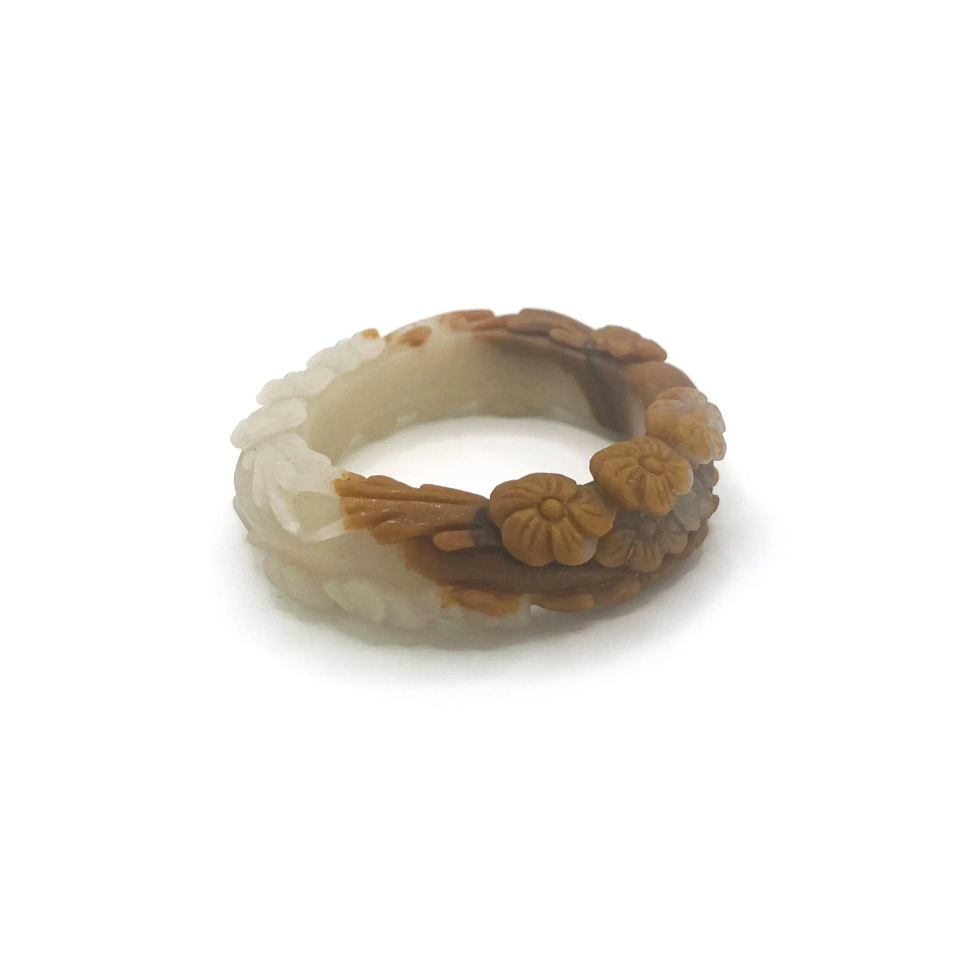 Carved jade bangle featuring three-dimensional floral motifs in warm caramel-colored Mongolian quartzite, hand-carved with an earthy and elegant finish.