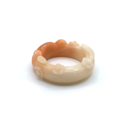 Unique jade bracelet in radiant pink-orange tones, with cat ears, tail, and blossoms carved in relief, plus a tiny sculpting flaw near one side – Miruzi