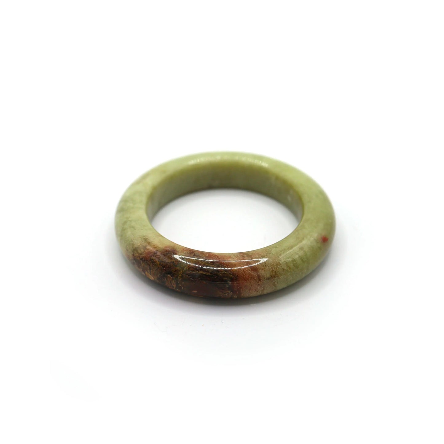 Classic full-circle jade bangle on clean white background with warm glow Miruzi