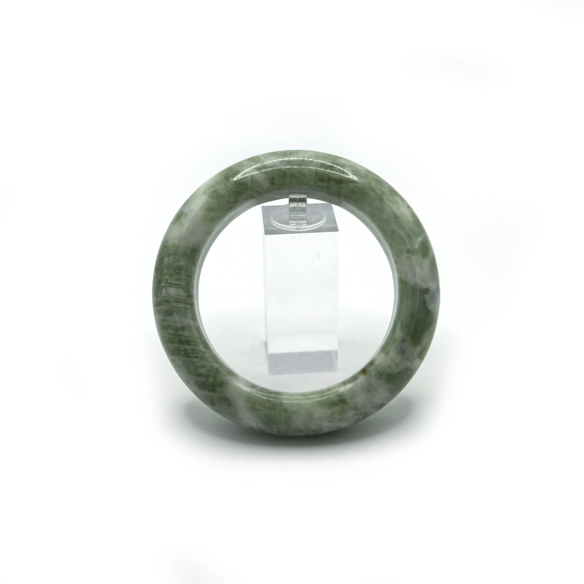 Light matcha jade bangle placed in soft jewelry pouch for safe storage - Miruzi