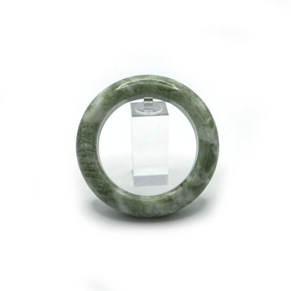 Light matcha jade bangle placed in soft jewelry pouch for safe storage - Miruzi