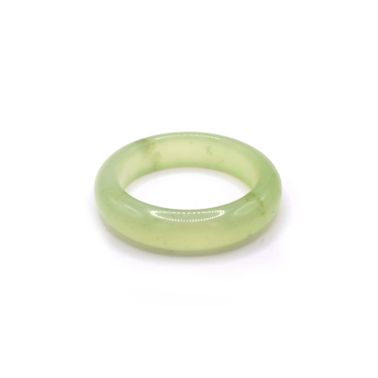 Pale green jade bracelet with jelly-like clarity and a soft mint tone, resting on light fabric to highlight its luminous translucence – Miruzi