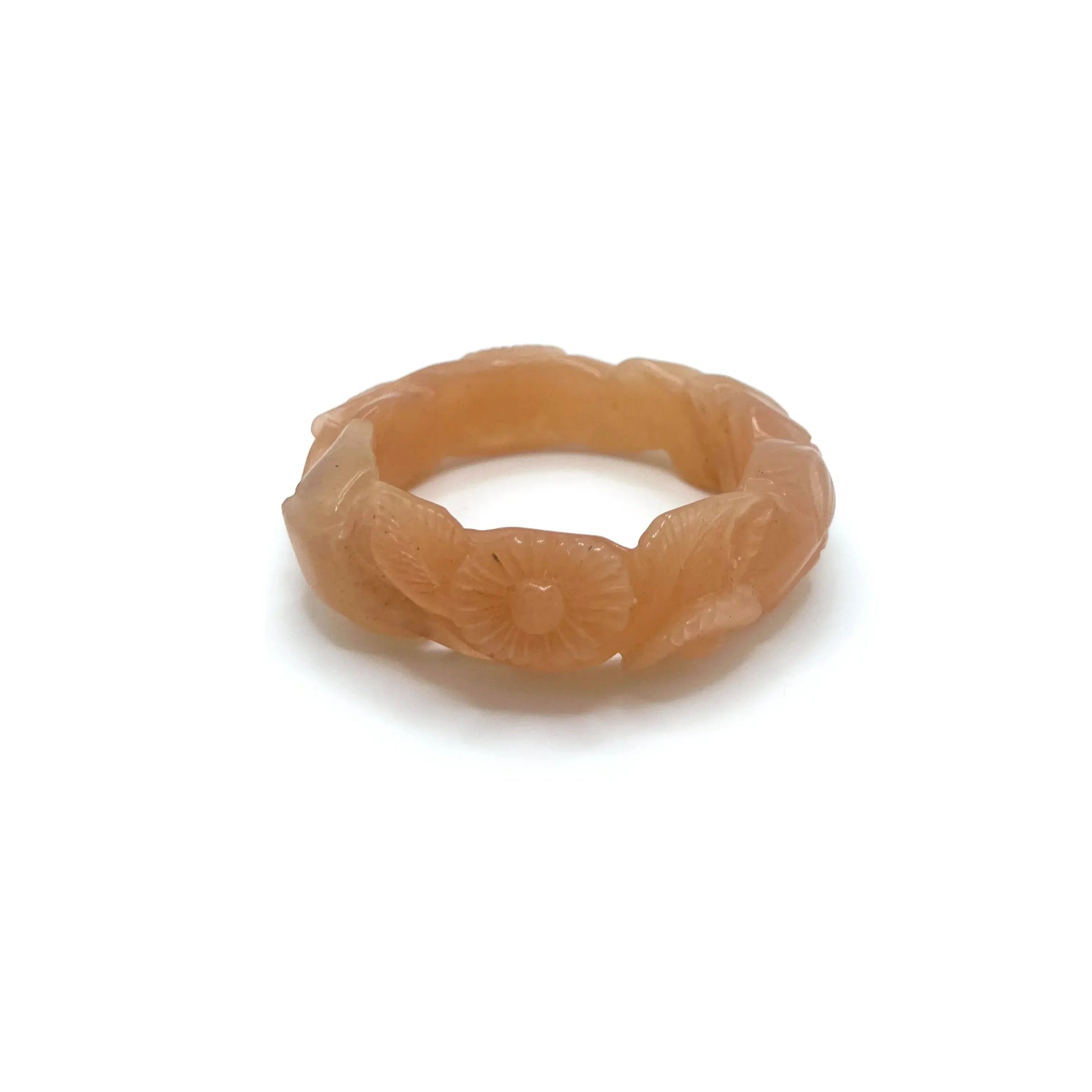 Twisted orange jade daisy bangle bracelet, showcasing a radiant blend of amber and blush tones in a playful, nature-inspired design.