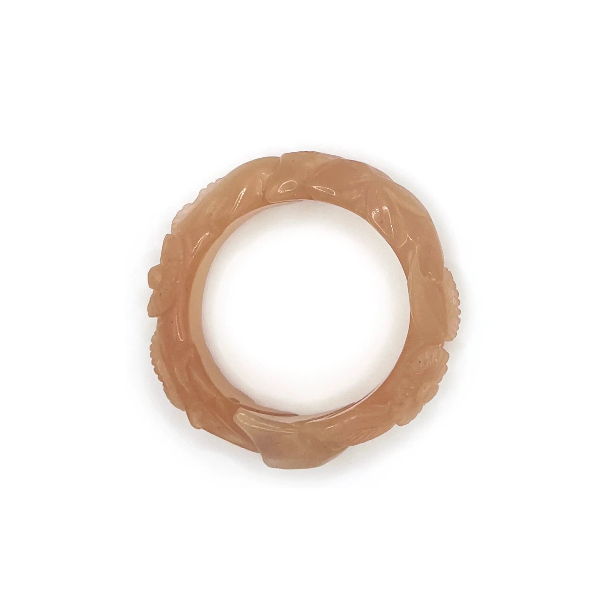 Twisted orange jade daisy bangle bracelet, showcasing a radiant blend of amber and blush tones in a playful, nature-inspired design.