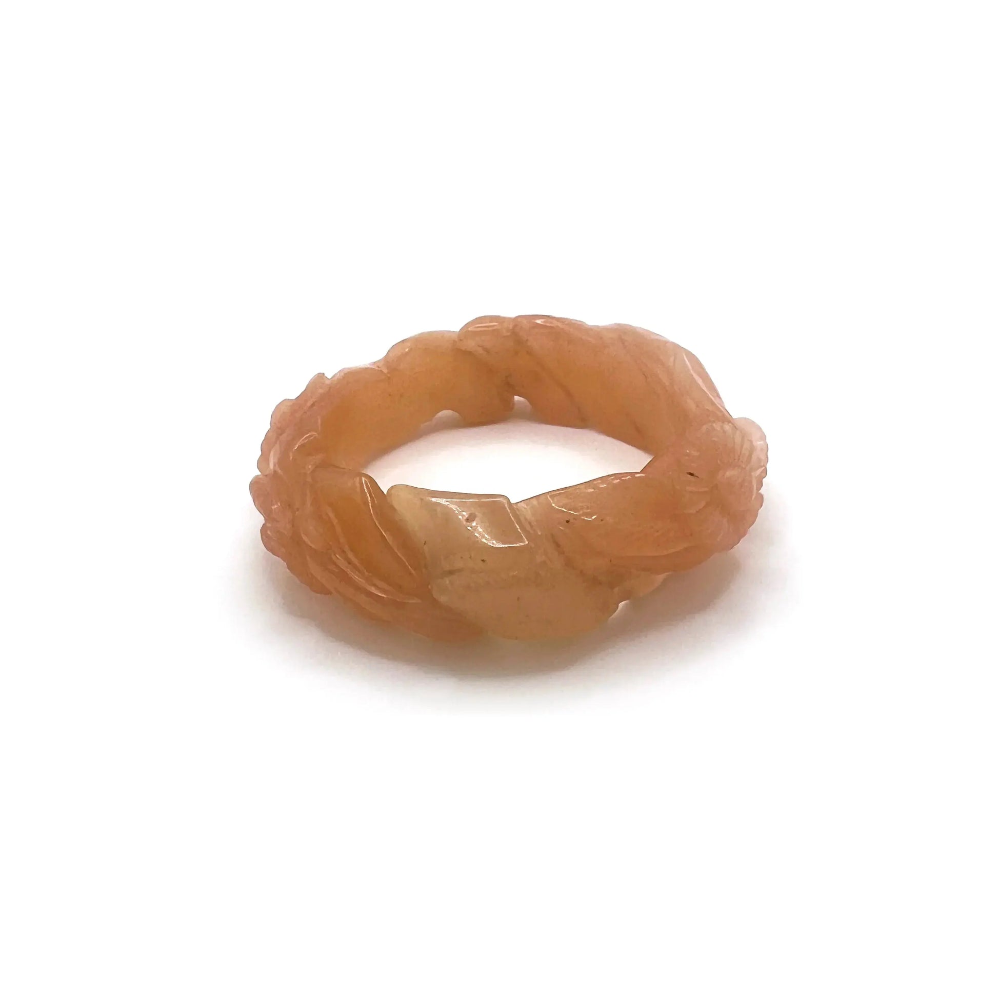 Twisted orange jade daisy bangle bracelet, showcasing a radiant blend of amber and blush tones in a playful, nature-inspired design.