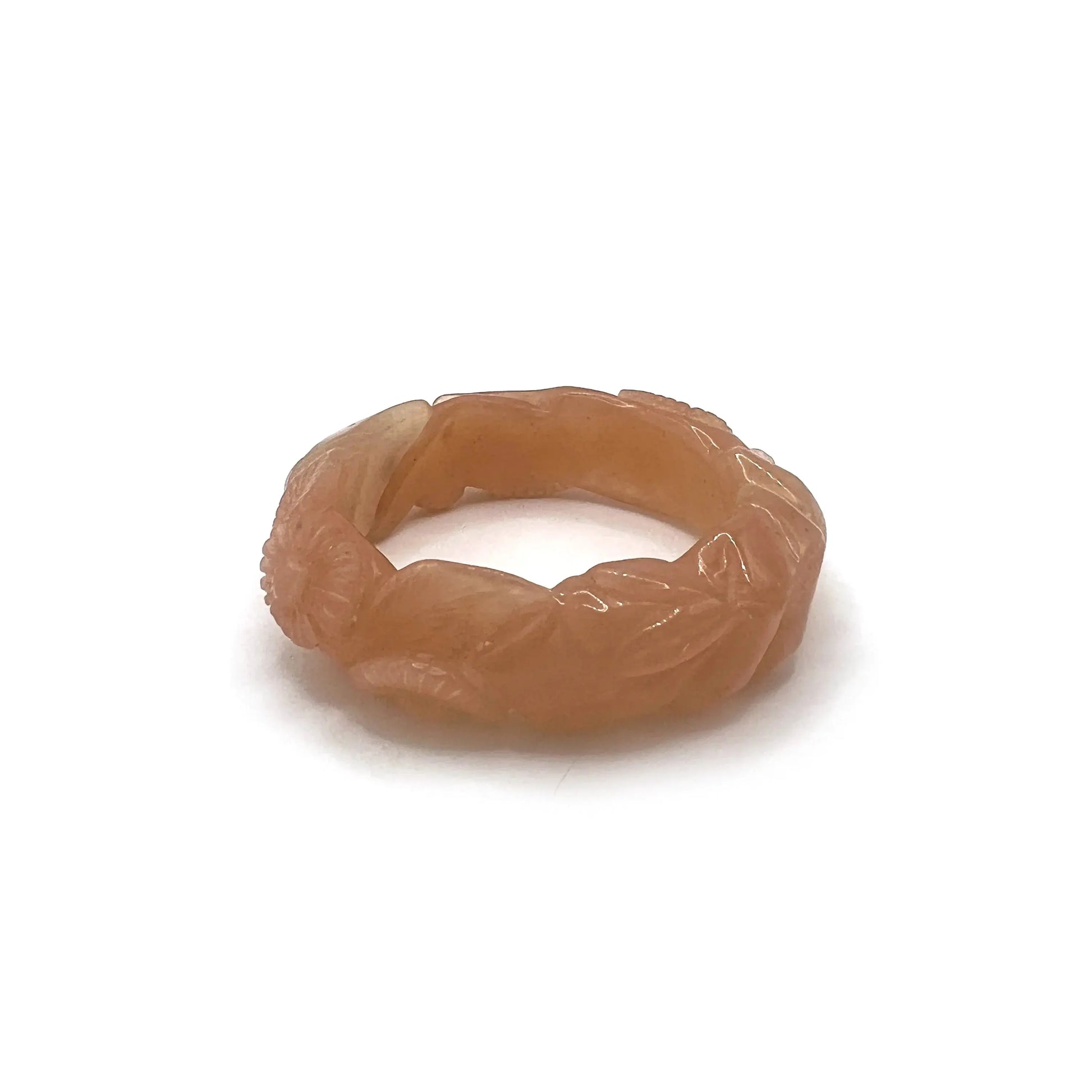 Twisted orange jade daisy bangle bracelet, showcasing a radiant blend of amber and blush tones in a playful, nature-inspired design.
