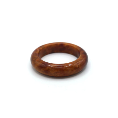 Crimson jade bracelet inside a soft jewelry pouch showing natural variations Miruzi
