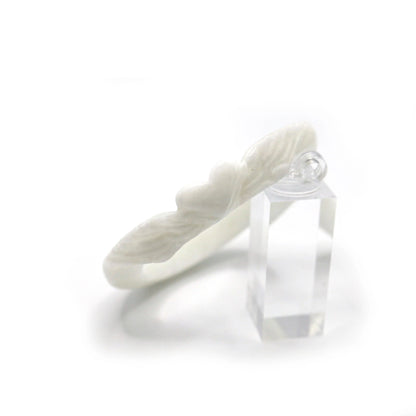 Hand-carved quartzite jade bangle with a central heart motif and flowing feather accents, expressing quiet love and protection – Miruzi