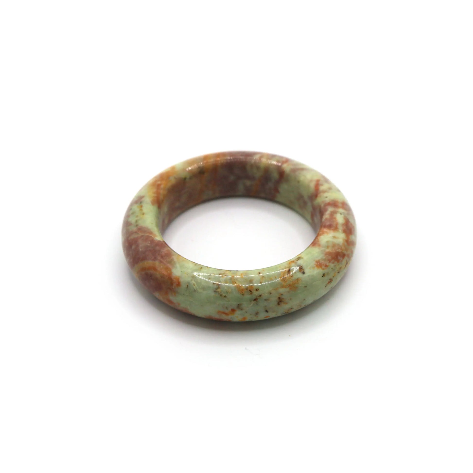 Jade bangle styled with clay-colored silk and cream knit textiles Miruzi