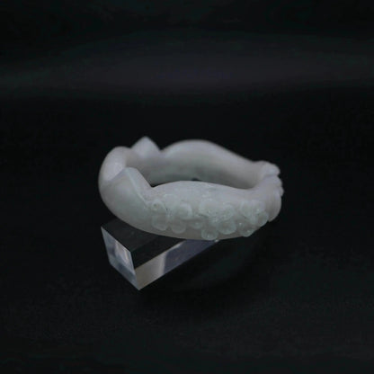 A sculptural white jade bracelet featuring refined feline and floral details in a full-circle, hand-polished silhouette – Miruzi

