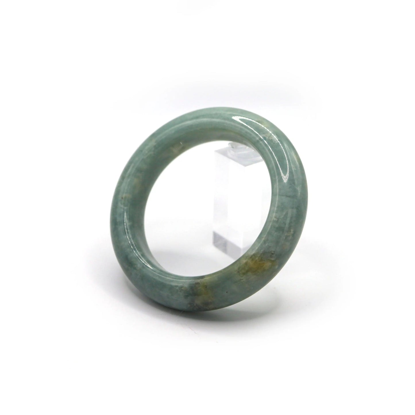 Side view of jade bracelet showing scattered flecks of white and yellow Miruzi