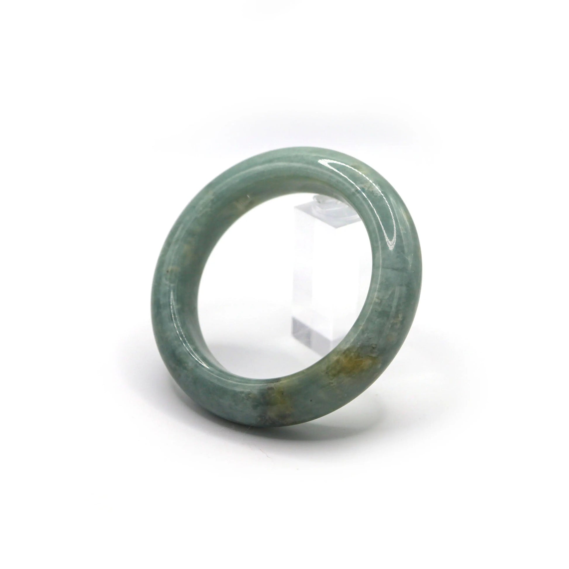 Side view of jade bracelet showing scattered flecks of white and yellow Miruzi