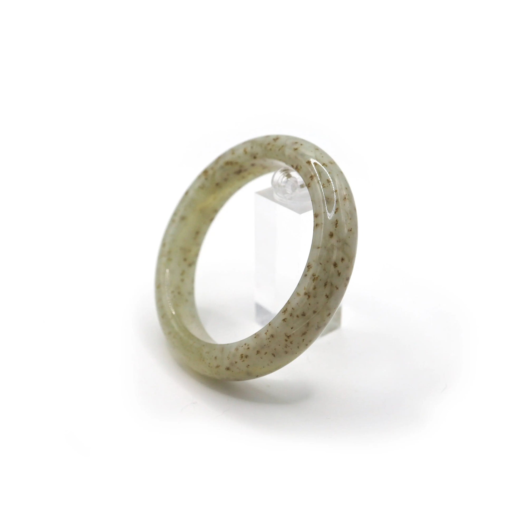 Close-up of beige serpentine jade bangle featuring unique brown floral-like inclusions in a luminous, clear-toned base – Miruzi