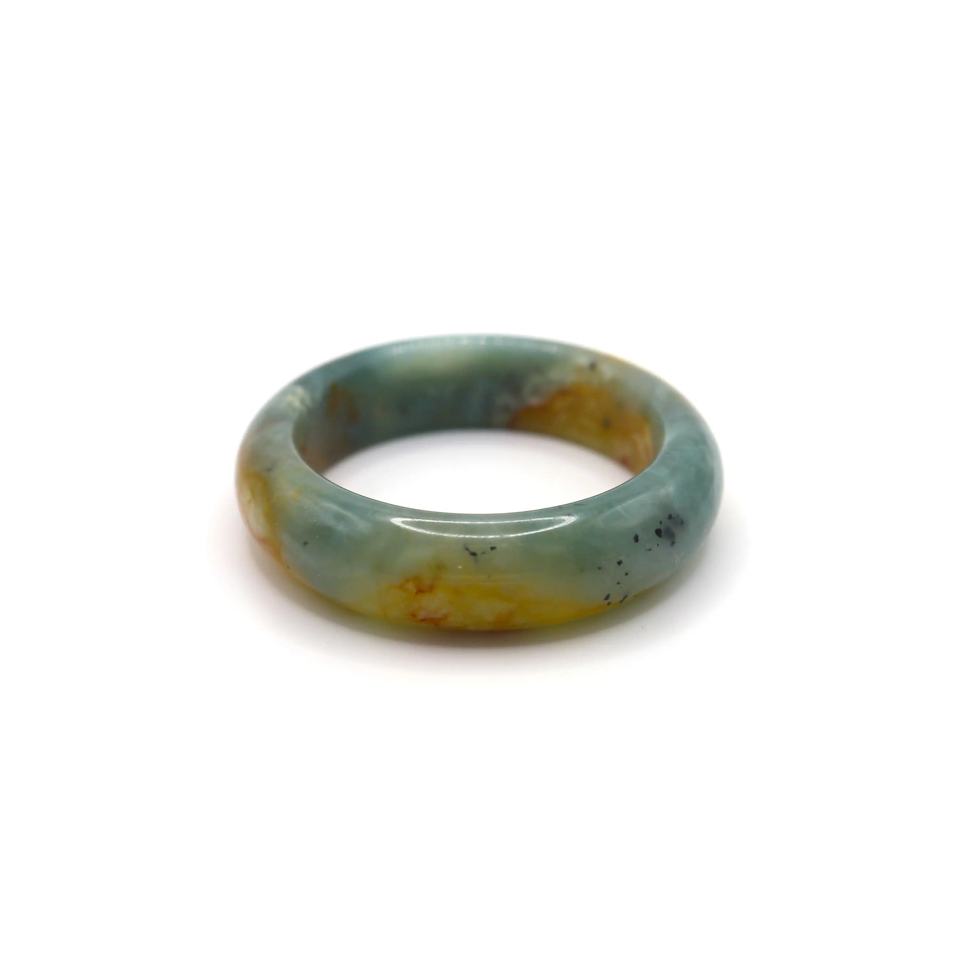 Elegant round jade bangle crafted from deep blue jade, featuring organic yellow and white inclusions in a smooth, timeless form – Miruzi