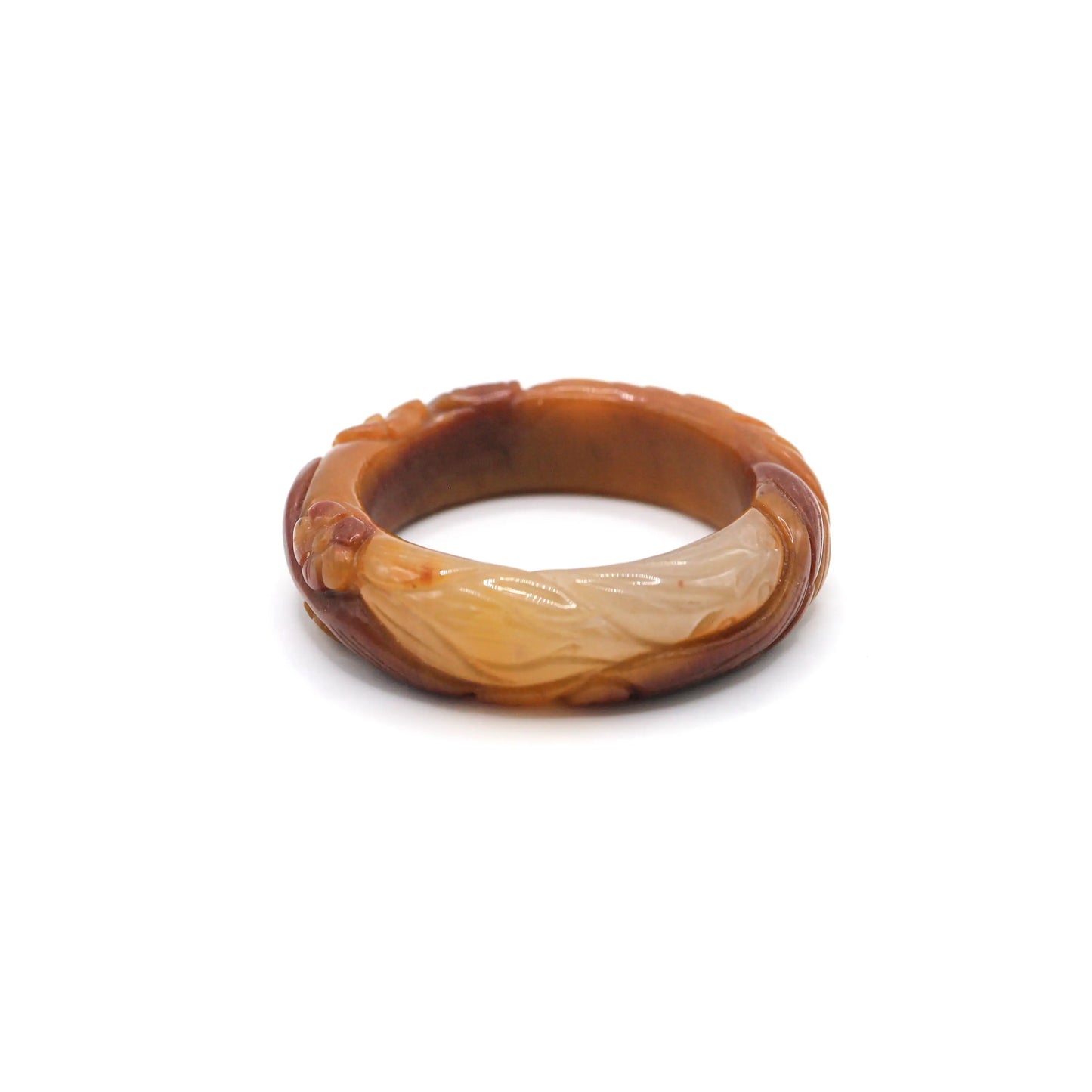 Smoothly polished jade bangle in saturated orange with clear floral details, partial translucency, and refined petal relief – Miruzi