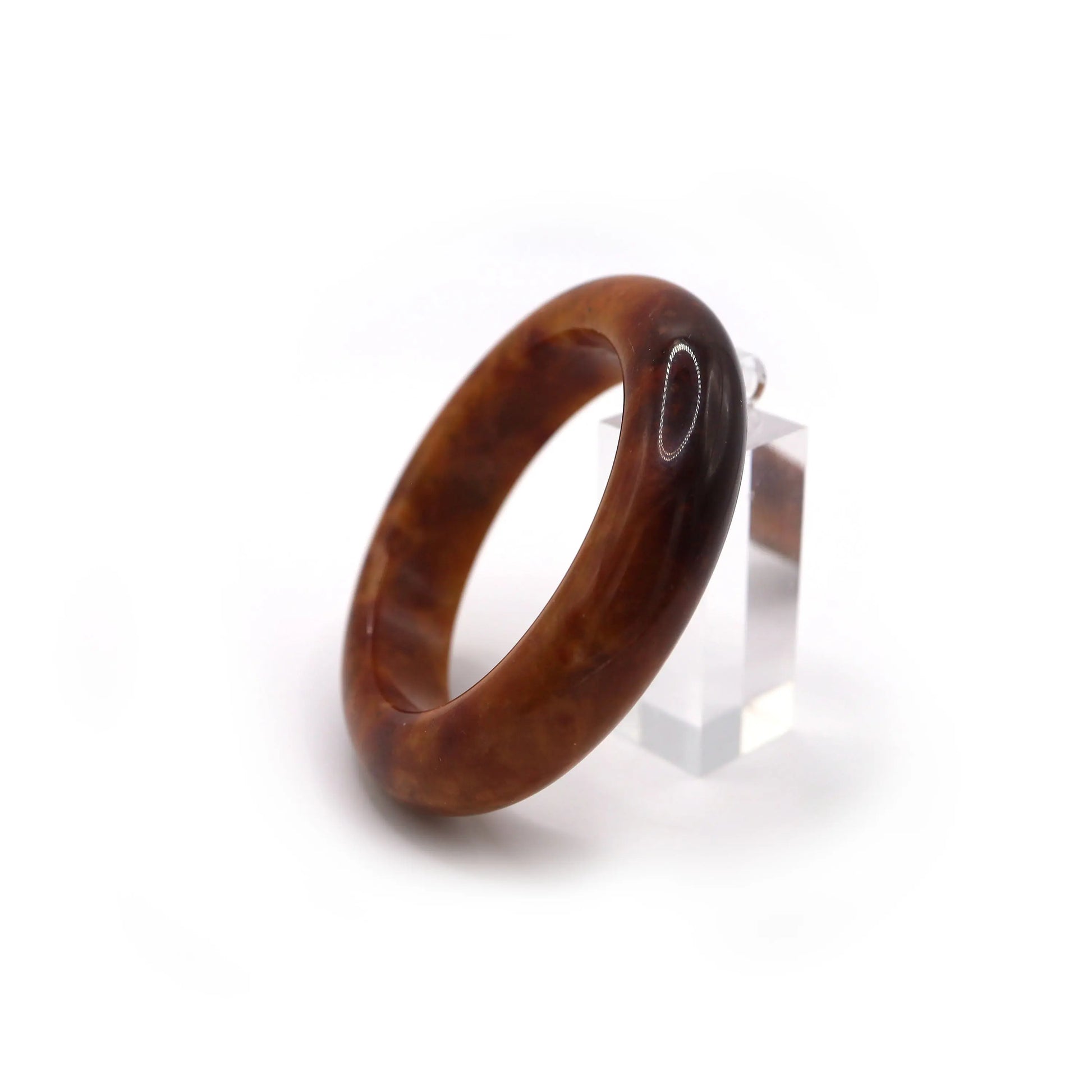 Red jade bracelet glowing under sunlight, highlighting its deep color and texture Miruzi