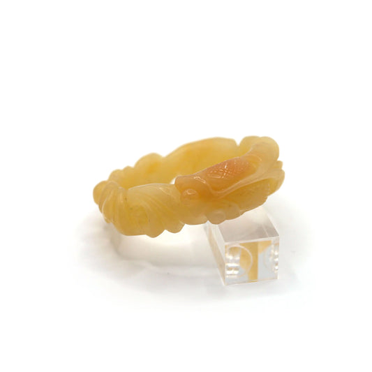 Vivid yellow jade bracelet with sculptural relief of a goldfish and blooming lotus, representing abundance and peace in natural stone – Miruzi