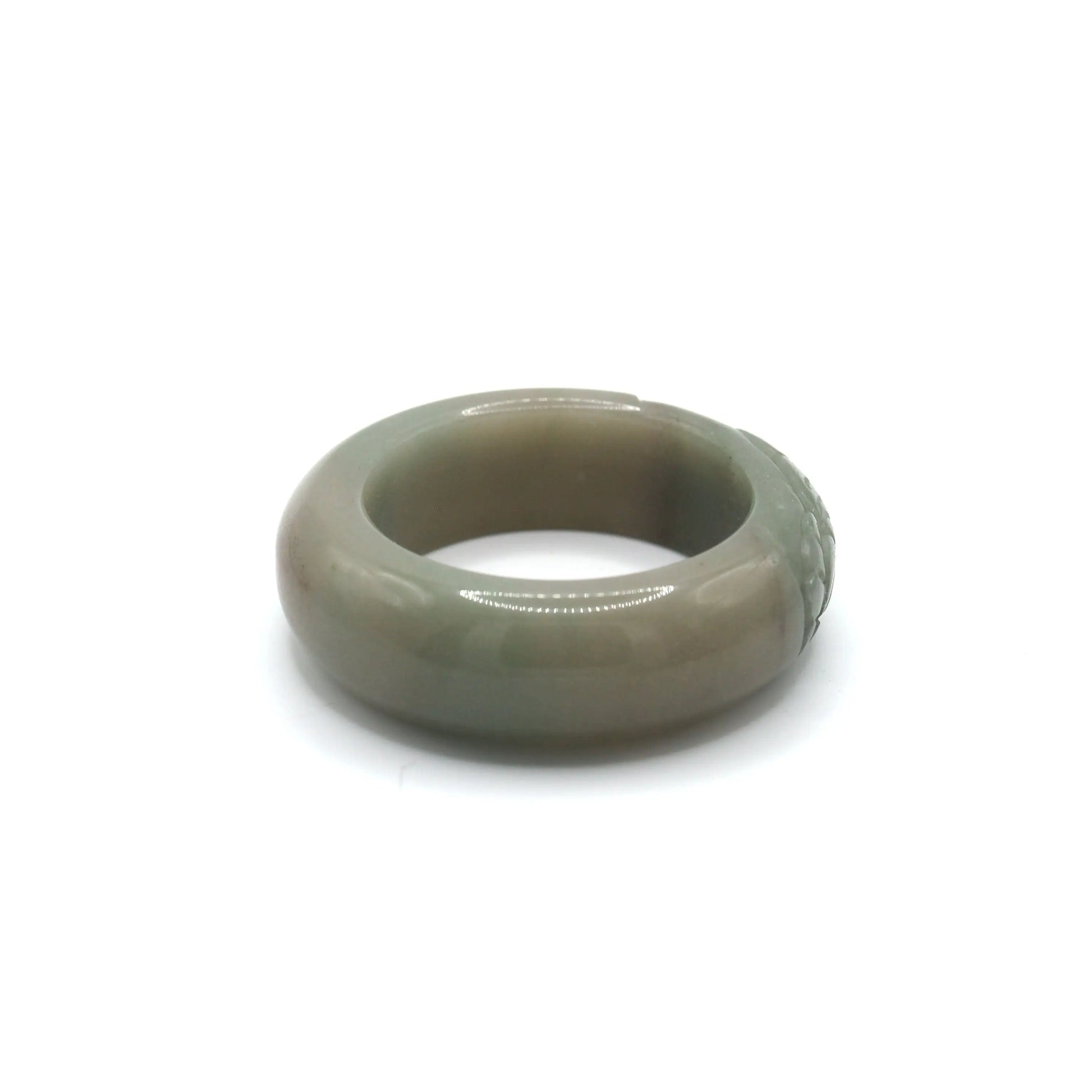 Mongolian jade bracelet featuring a lone floral carving in dark green detail, gracefully emerging from a minimalist soft green base – Miruzi
