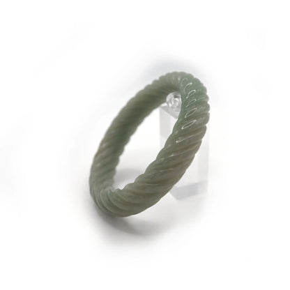 Twisted green jade bracelet featuring graceful motion and two coin-shaped carvings, blending form and tradition – Miruzi